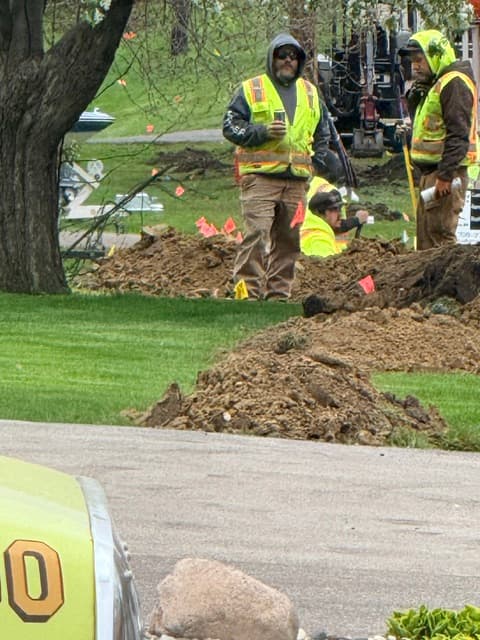 Miller Utilities crew hand-digging to expose an existing underground utility ahead of a bore